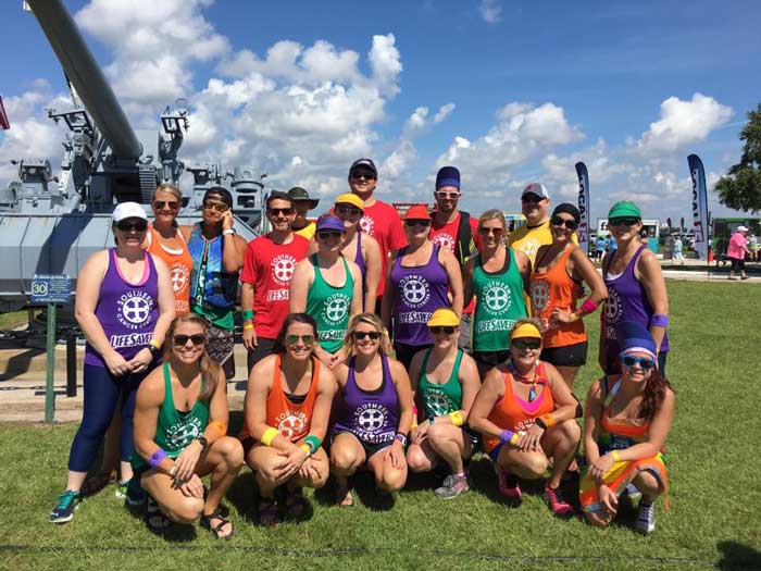 The group of people in Annual Dragon Boat Festival meet at Mobile.AL The group of people in Annual Dragon Boat Festival meet at Mobile.AL