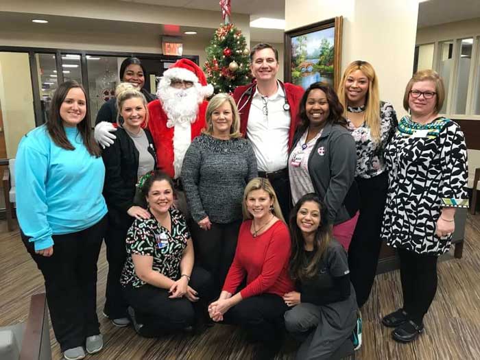 Team member clicking picture with Santa