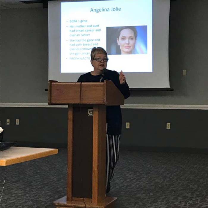 A senior woman giving presentation