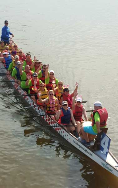 SCC's staff riding a boat at the Dragon Boat Festival in Alabama