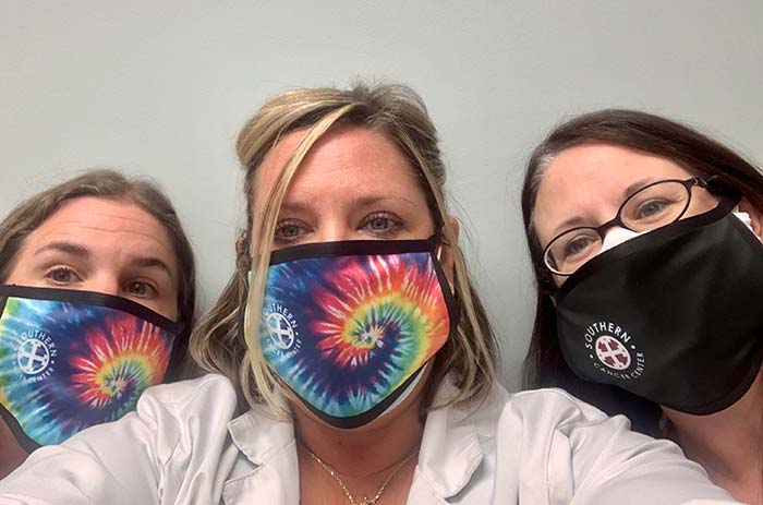 3 women wearing masks