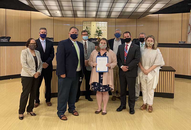 Team photo and employees wearing a mask in the reception area