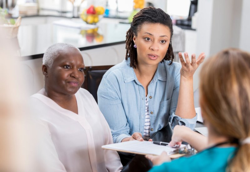 The Nurse explaining the genetic cancer to patients with caretaker The Nurse explaining the genetic cancer to patients with caretaker
