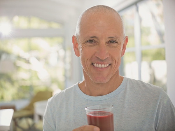 A man having a juice in the hand