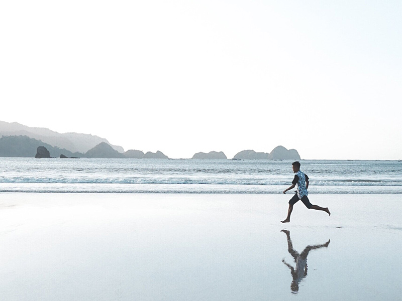 Young boy running on a beach